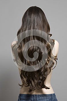 Rear View Of Topless Woman With Long Wavy Hair