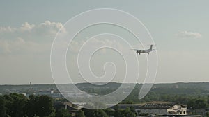 Rear view of twin engine jet airplane landing at the airport.