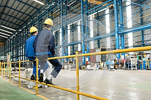 Rear view of two blue-collar workers during break photo