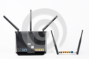 Rear view of  two Wi-Fi  routers, wireless devices with two  and three antennas on white background