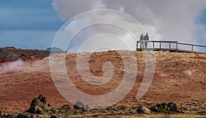 Rear view of unrecognizable people looking at the fumarole