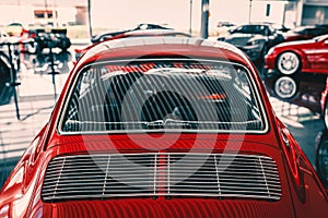 Rear view of vintage red car parked in garage