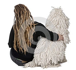 Rear view of a White Corded Poodle and a girl