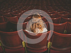 Rear view of woman in auditorium