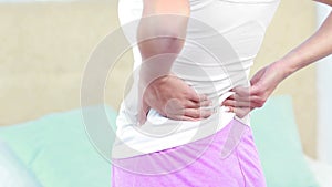 Rear view of woman with back pain