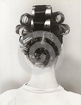 Rear view of woman with curlers in her hair