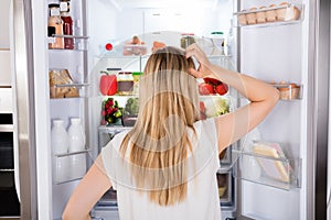 Rear View Of Woman Looking In Fridge photo