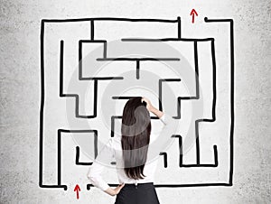 Rear view of a woman looking at a square maze