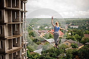 Rear view woman making step on the slackline rope