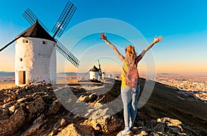 Rear view woman posing against windmills in Consuegra