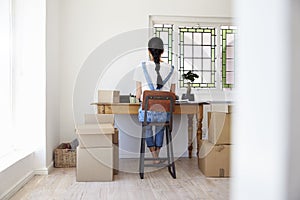 Rear View Of Woman Running Business From Home Dispatching Goods