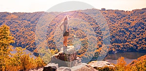 Rear view of woman sitting and looking at river dordogne