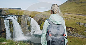 Rear view of woman tourist enjoying Kirkjufellsfoss in northern Iceland