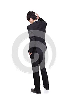 Rear view of young business man confused
