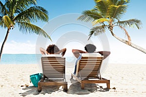 Couple Relaxing On Deck Chair