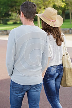 Rear view young couple walking in park