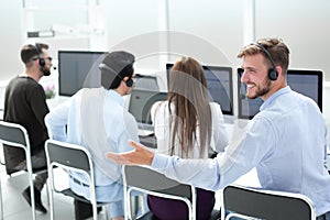 Rear view. young customer service agent sitting at his Desk