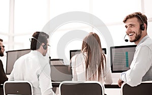 Rear view. young customer service agent sitting at his Desk