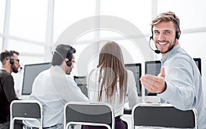 Rear view. young customer service agent sitting at his Desk