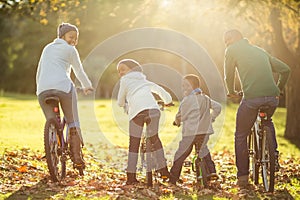 Rear view of a young family doing a bike ride