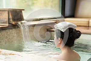 Rear view of young girl enjoy the hot springs