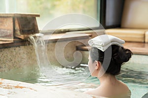 Rear view of young girl enjoy the hot springs photo