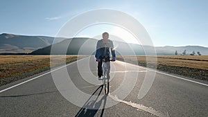 Rear View of a Young Man With Bicycle on Summer Nature Background. Healthy Lifestyle Concept. 20s 4k.