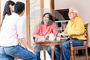 Rear view of young man and woman visiting parents at home