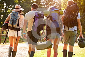 Rear View Of Young People Going Camping At Music Festival