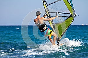 Rear view of young windsurfer