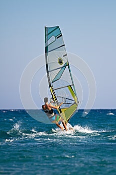Rear view of young windsurfer