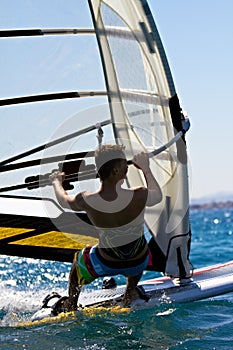 Rear view of young windsurfer