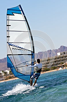 Rear view of young windsurfer