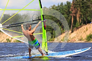Rear view of young windsurfer close-up
