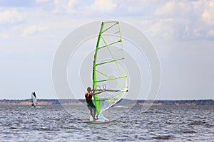 Rear view of young windsurfer