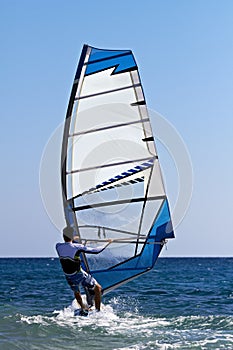 Rear view of young windsurfer