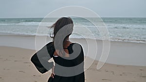 Rear view of young woman looking at the ocean