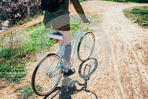 Rear view young woman riding bicycle