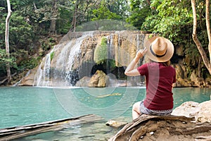 Rear view of young woman traveling in Erawan waterfall