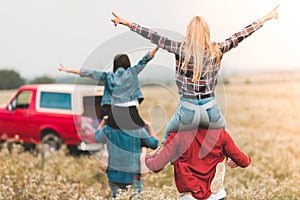 rear view of young women riding on boyfriend