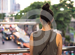 Rear view young women see the traffic jam in the city bangkok jatujan