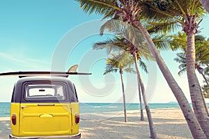 Rear of vintage car parked on the tropical beach seaside with a surfboard on the roof