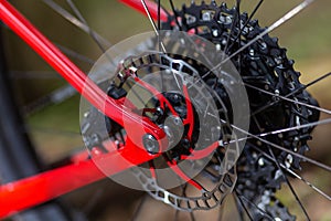 Rear wheel disc brake rotor of the grey sport bike close up on the grey background