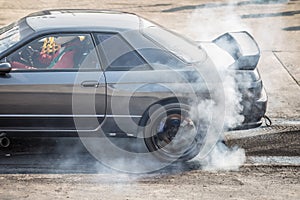 Rear wheel drive sport car burning tire for warm up before competition start to increase type temperature for good traction