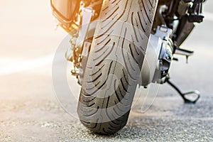 Rear wheel of sports motorcycle on road. Motorbike parked on a s