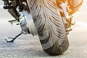 Rear wheel of sports motorcycle on road. Motorbike parked on a s