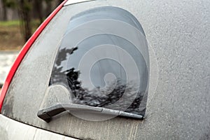 Rear window side view of a dirty car.