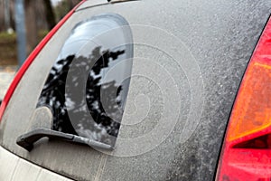 Rear window side view with stop signal of a dirty car.