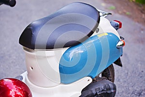 Rear wing and headlight of blue retro scooter