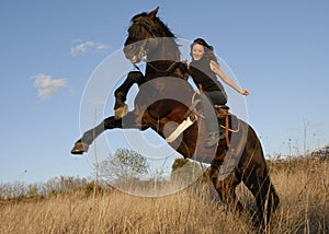 Rearing stallion and girl